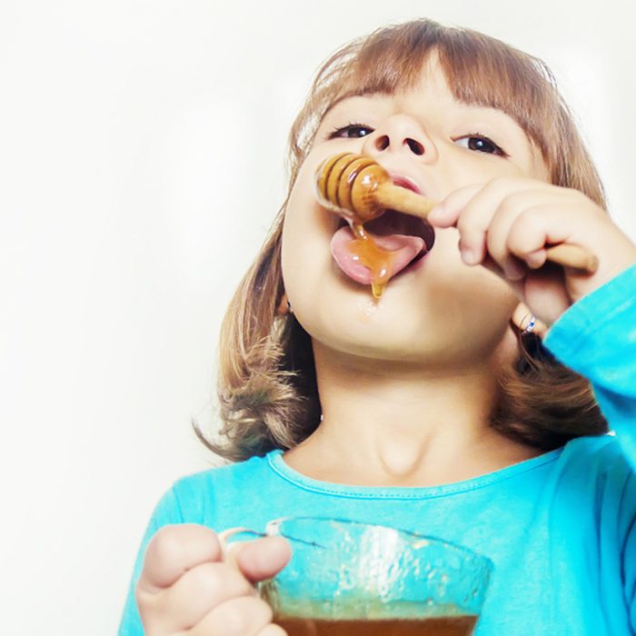 child eating honey
