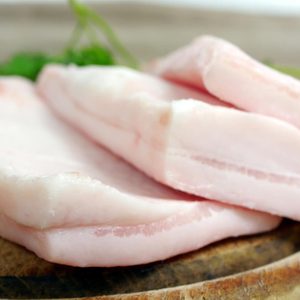 pork fat with parsley on board background