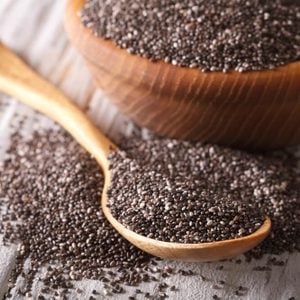 Healthy Chia seeds in a wooden spoon on the table close-up. horizontal