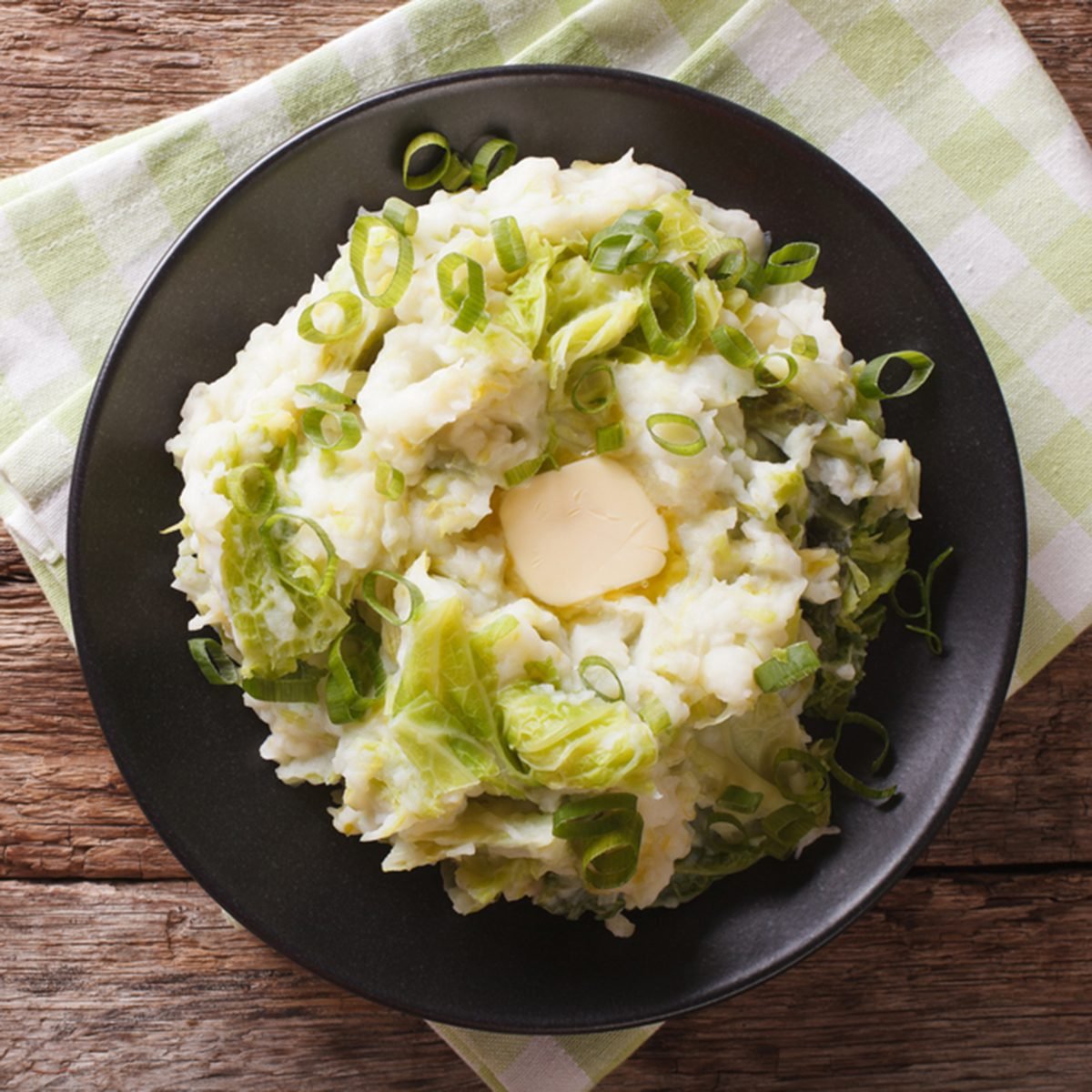 Irish colcannon - mashed potatoes with savoy cabbage and butter closeup on the table. horizontal view from above; Shutterstock ID 475578826