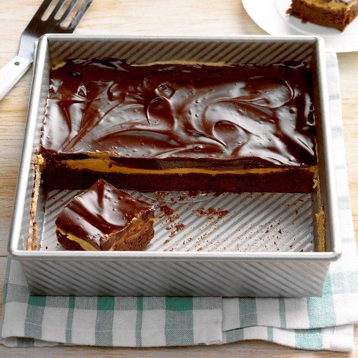 A half-eaten pan of frosted chocolate cookie bars.