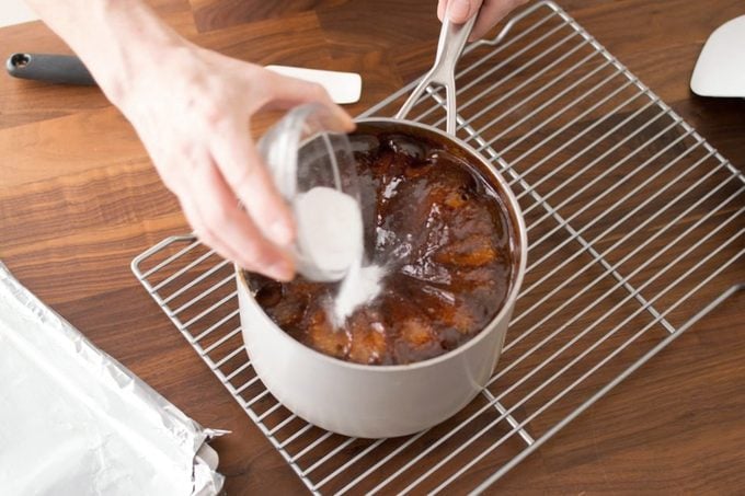 adding baking soda into the pot while it rests on a cooling rack