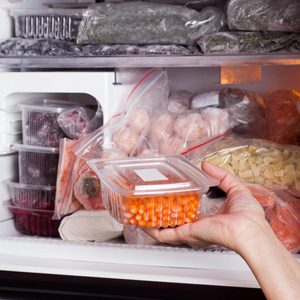 Frozen food in the refrigerator. Vegetables on the freezer shelves
