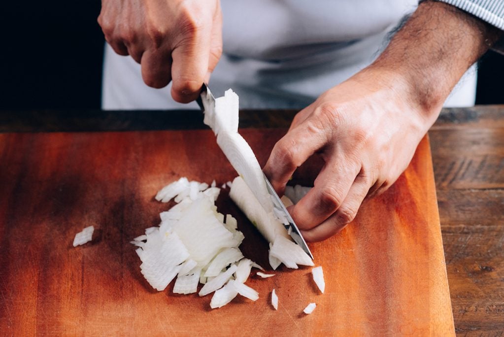 Chef chopping an onion