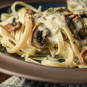 Fancy organic fetuccine pasta with creamy alfredo mushroom sauce