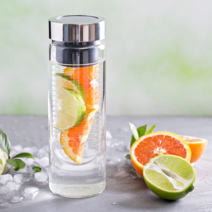 Infused water with orange and lime in a bottle