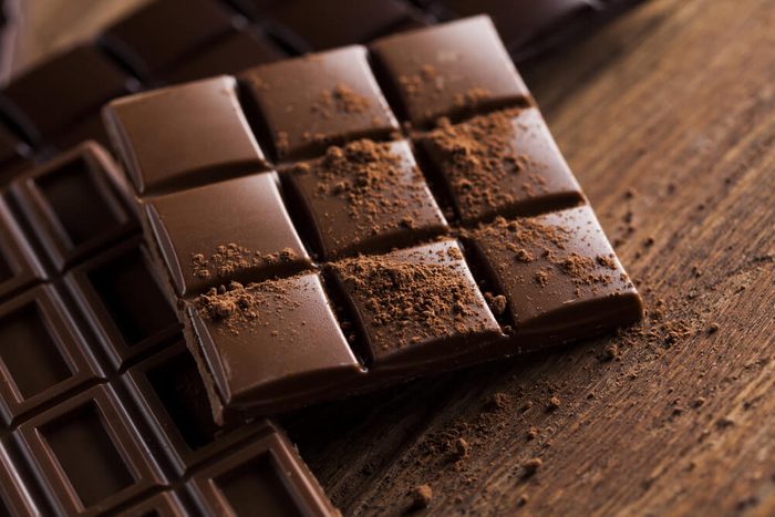 Milk and dark chocolate on a wooden table