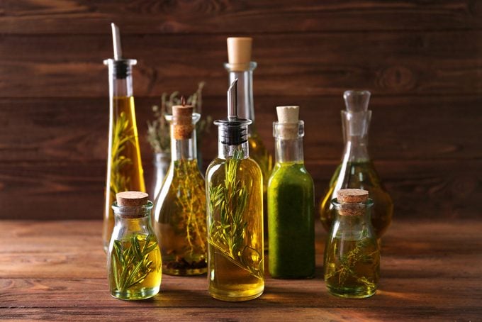 Composition of bottles with oil on wooden background. Keto diet-friendly oils.