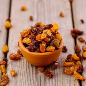 bowl of raisins. raisins on a wooden background