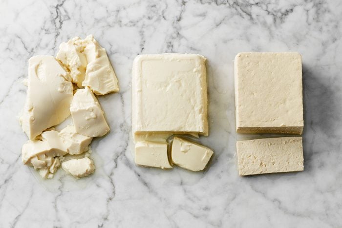 Types Of Tofu blocks on a marble surface; silken, soft, and firm tofu