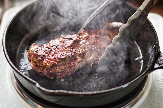 Angus steak fried on vegetable oil on cast iron