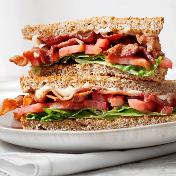 two halves of a BLT sandwich stacked on top of each other