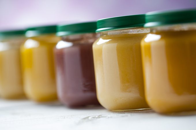 healthy ready-made baby food in jars on a wooden table