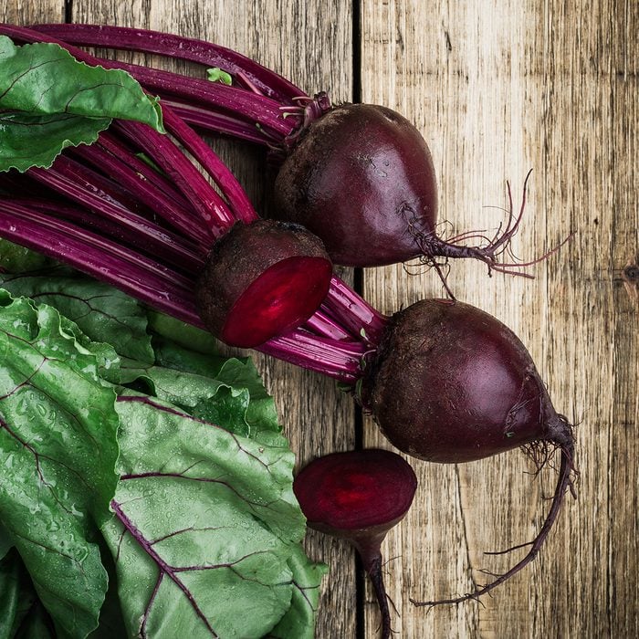 Fresh organic beetroot over wooden background viewed from above