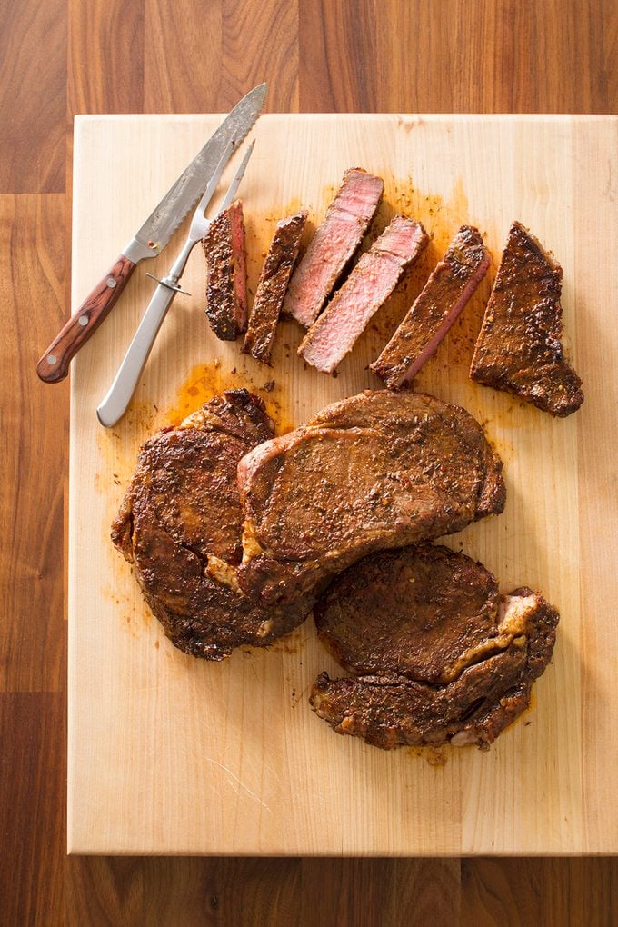 Juicy grilled steak on a wooden cutting board.