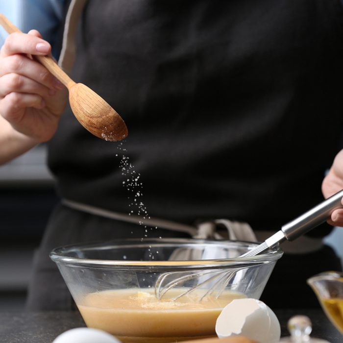 Young woman cooking in kitchen, closeup; Shutterstock ID 574318603; Job (TFH, TOH, RD, BNB, CWM, CM): TOH