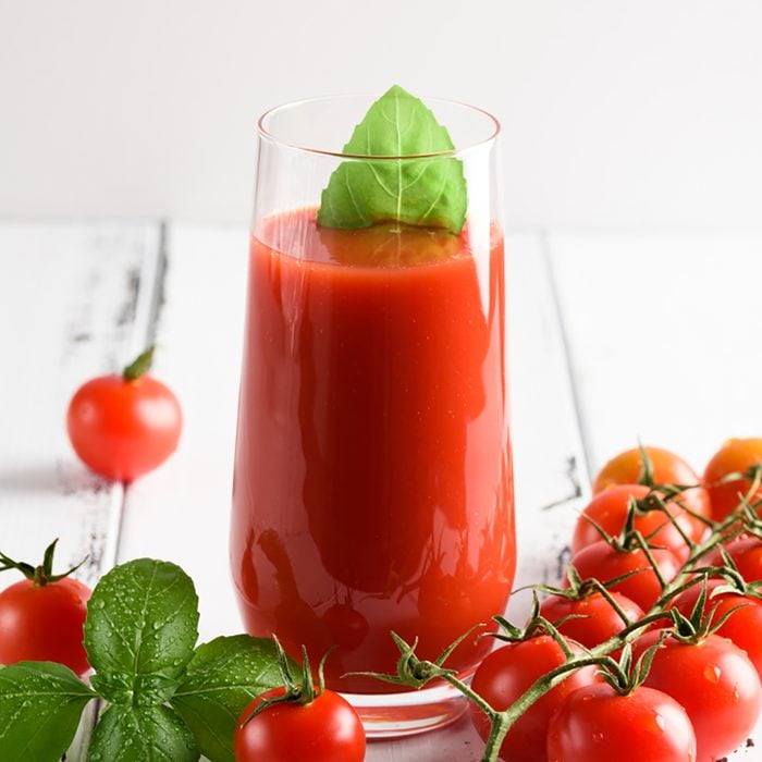 Tomato juice in a glass with a cherry and basil on a light background; Shutterstock ID 1011529984; Job (TFH, TOH, RD, BNB, CWM, CM): TOH