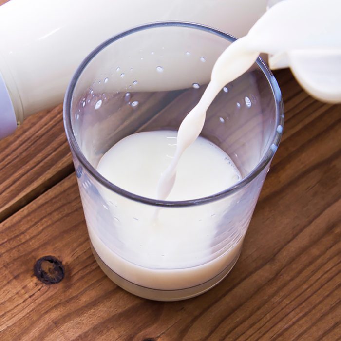 bottle with milk and glass of milk on wooden table; Shutterstock ID 1131584663; Job (TFH, TOH, RD, BNB, CWM, CM): TOH