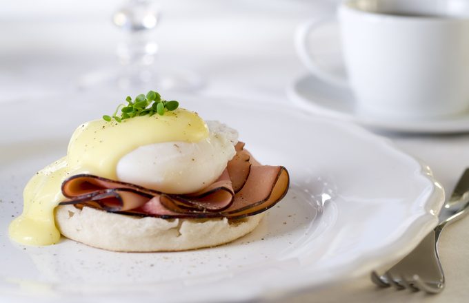 Eggs Benedict with ham and hollandaise sauce.