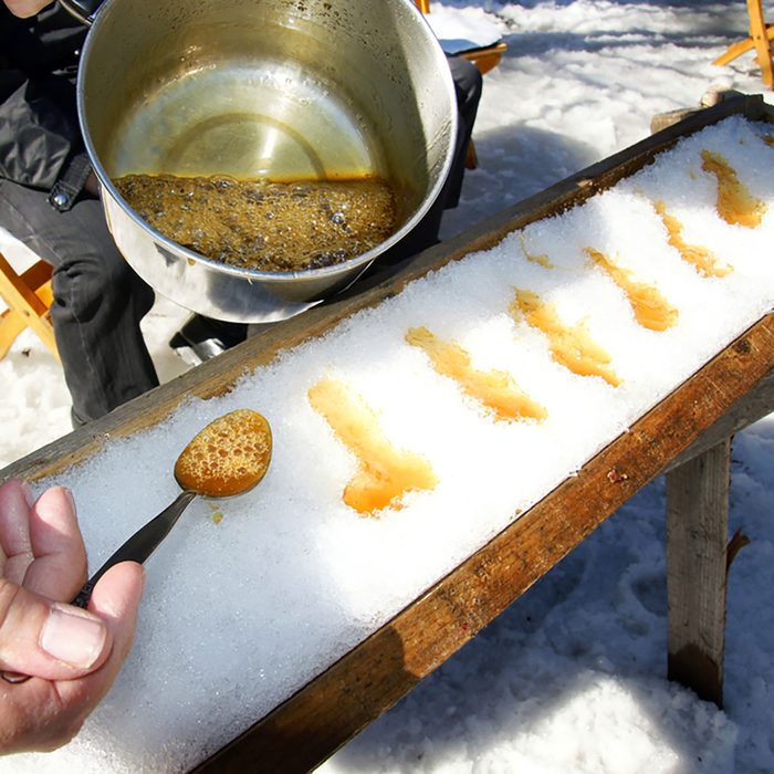 Making sugar on snow, or maple toffee at the sugar shack in Quebec, Canada