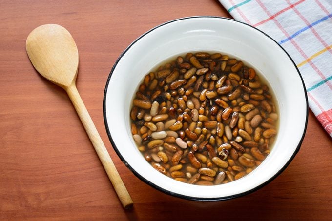 Brown beans soaking in water before to be cooked in a pot for the preparation of a tasty soup.