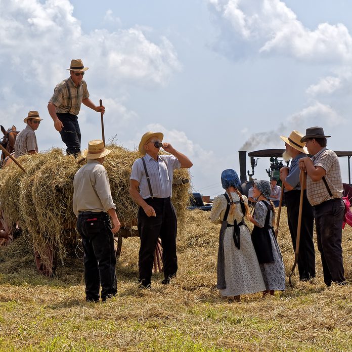 Two Mennonite girls take water to the hay crew