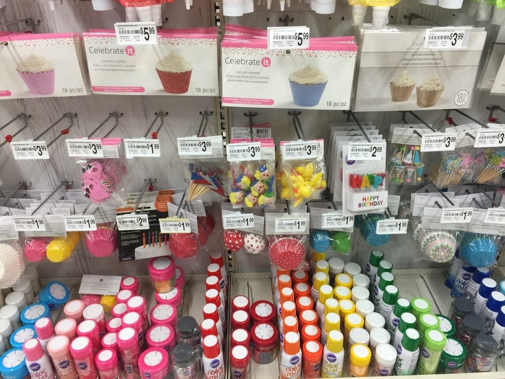Colorful baking supplies on display at a craft store, including food coloring and sprinkles