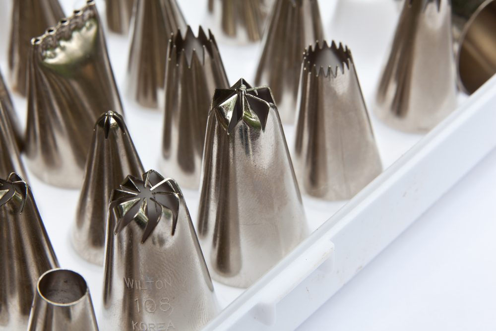 A closeup photo of metal frosting tips; 
