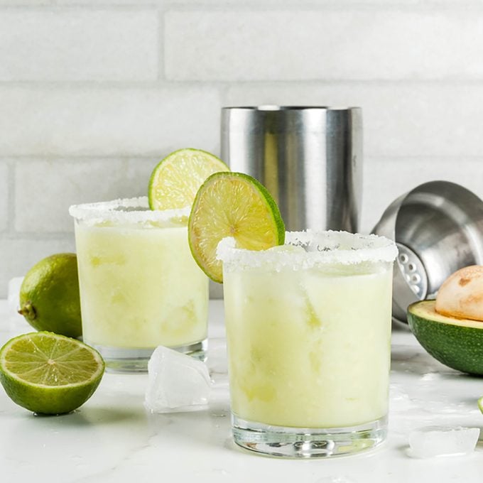 Alcoholic cocktail recipes and ideas. Avocado and lime margarita with salt, on a white marble kitchen table. Copy space; Shutterstock ID 735617161; Job (TFH, TOH, RD, BNB, CWM, CM): TOH