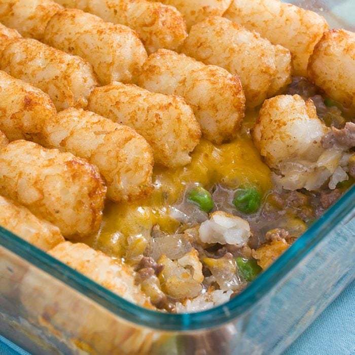Tater Tots Casserole - Casserole made of tater tots, cheddar cheese, ground beef, peas, and onions