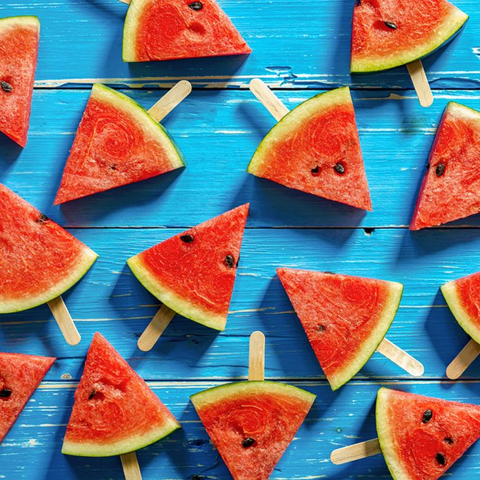 Watermelon slice popsicles on a blue rustic wood background; Shutterstock ID 439368238; Job (TFH, TOH, RD, BNB, CWM, CM): Taste of Home