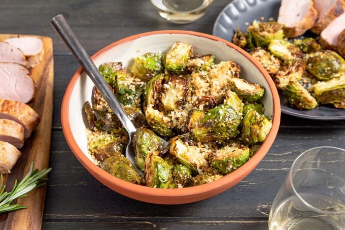 Air Fryer Brussels Sprouts in Terracotta Bowl on Wooden Surface