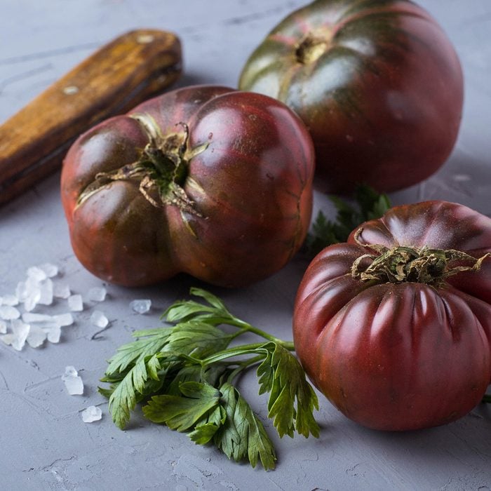 Tomato, Salt, Parsley And Knife On Gray Concrete Background