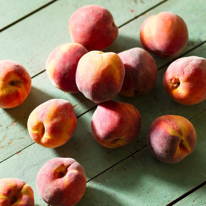 Fresh Peaches On Green Wood Surface