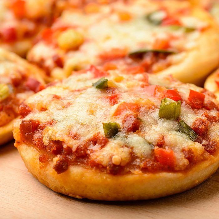 Mini pizzas on wooden board.; Shutterstock ID 367393364