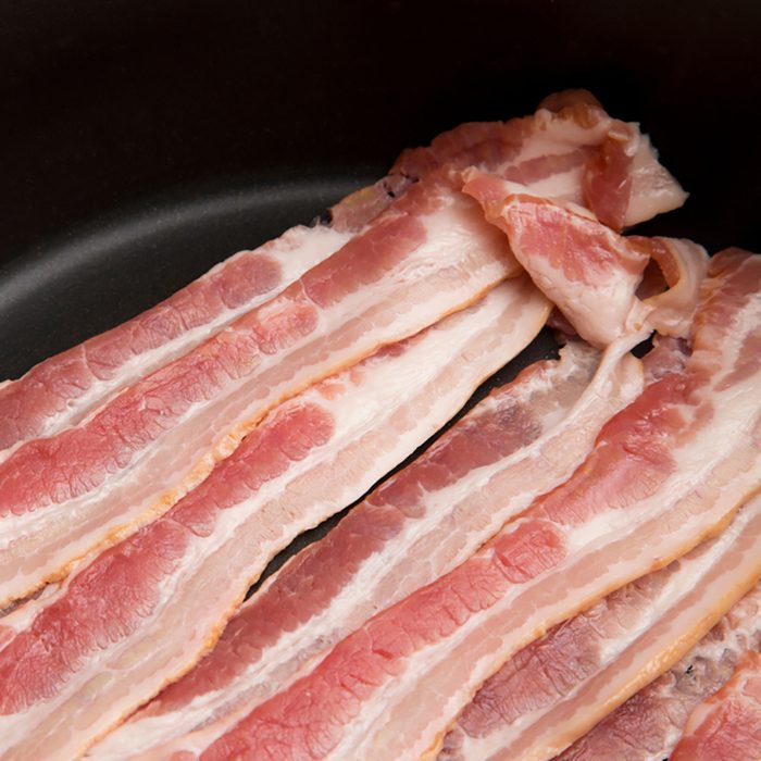 Raw American Style Bacon in a Frying Pan