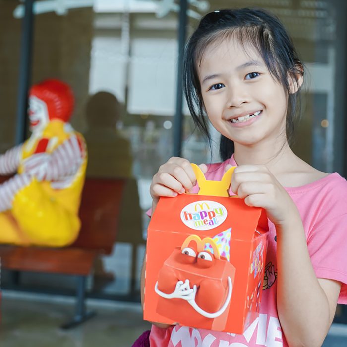 BANGKOK,THAILAND - MARCH 10,2018 :little Asian girl holding happy meal box at McDonald's restaurant; Shutterstock ID 1047090799; Job (TFH, TOH, RD, BNB, CWM, CM): Taste of Home