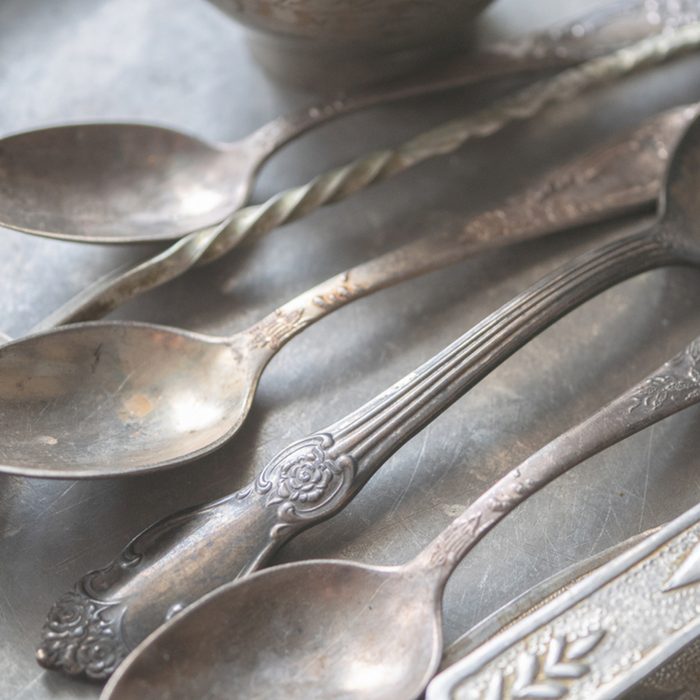 close up shot of silver spoons vintage silverware utensil cutlery, selective focus on center of image. flat vintage look. low angle; Shutterstock ID 1171915342