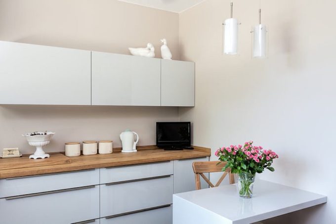 white kitchen cabinets and island with pink flowers