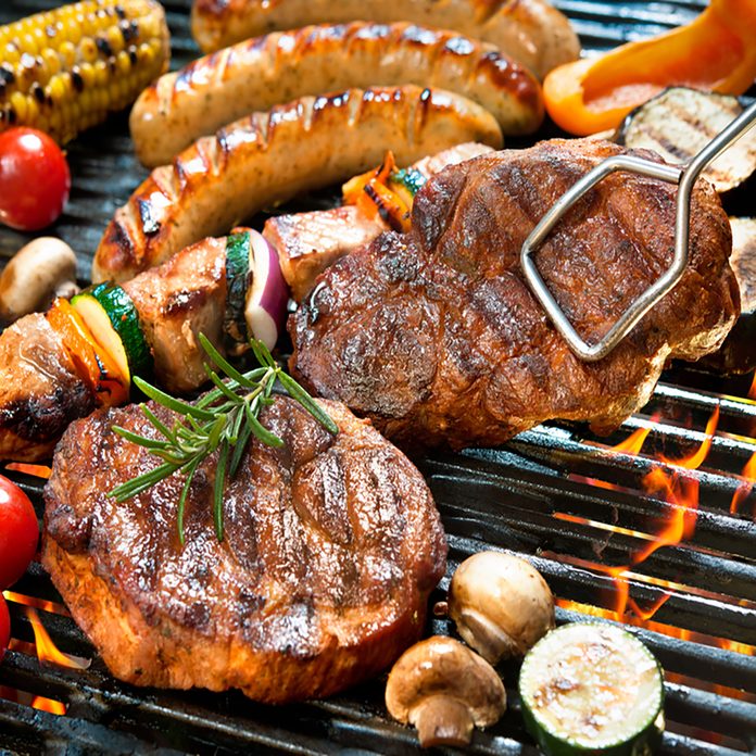 grilling safety Assorted delicious grilled meat with vegetables over the coals on barbecue