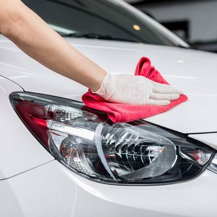 Car detailing series : Worker cleaning white car; Shutterstock ID 367602932