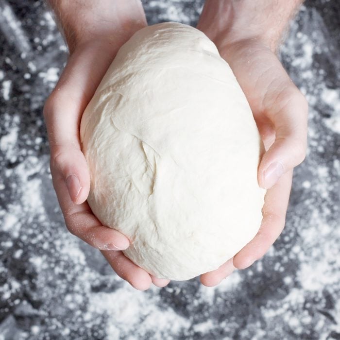 Hands holding a finished clean dough