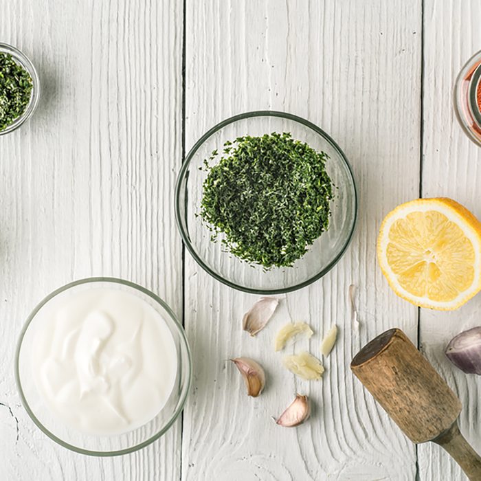 Natural yogurt and different seasoning on the white wooden table top view; Shutterstock ID 430402339