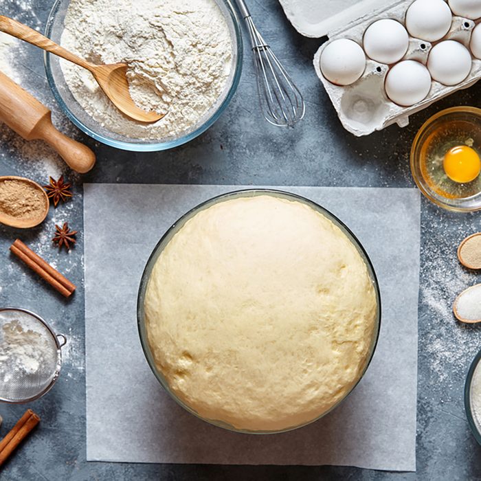 Dough preparation recipe bread, pizza or pie making ingridients, food flat lay on kitchen table background. Working with butter, milk, yeast, flour, eggs, sugar pastry or bakery cooking