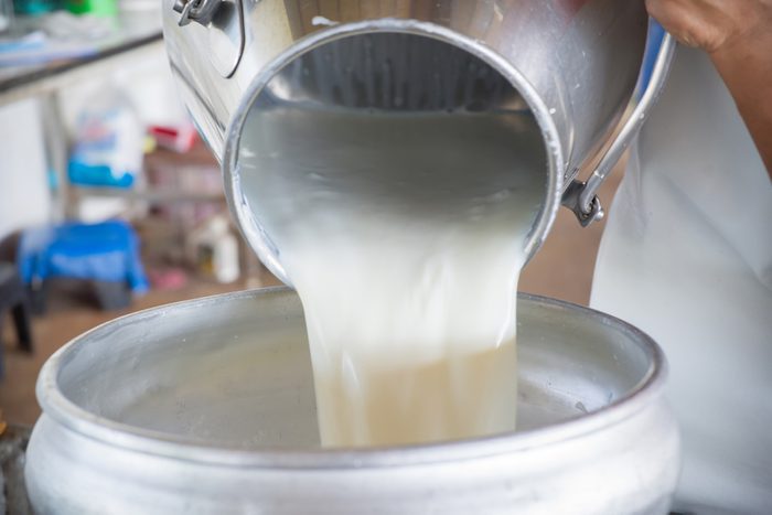 Pour raw milk into a bucket