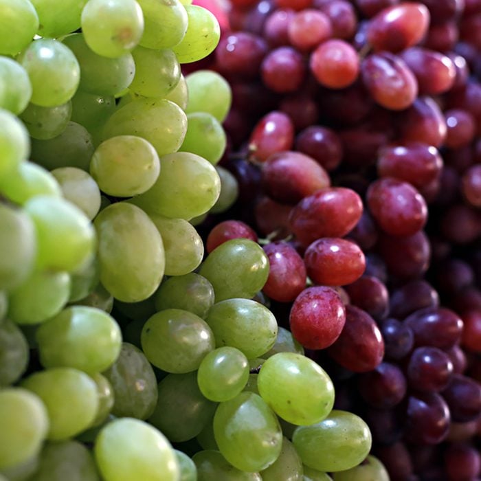 Healthy fruits Red wine grapes background/ dark grapes/ blue grapes/wine grapes,Red wine grapes background/dark grapes,blue grapes,Red Grape in a supermarket local market bunch of grapes ready to eat;