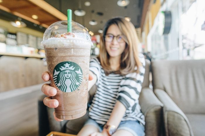 women holding a venti cup of frappuccino