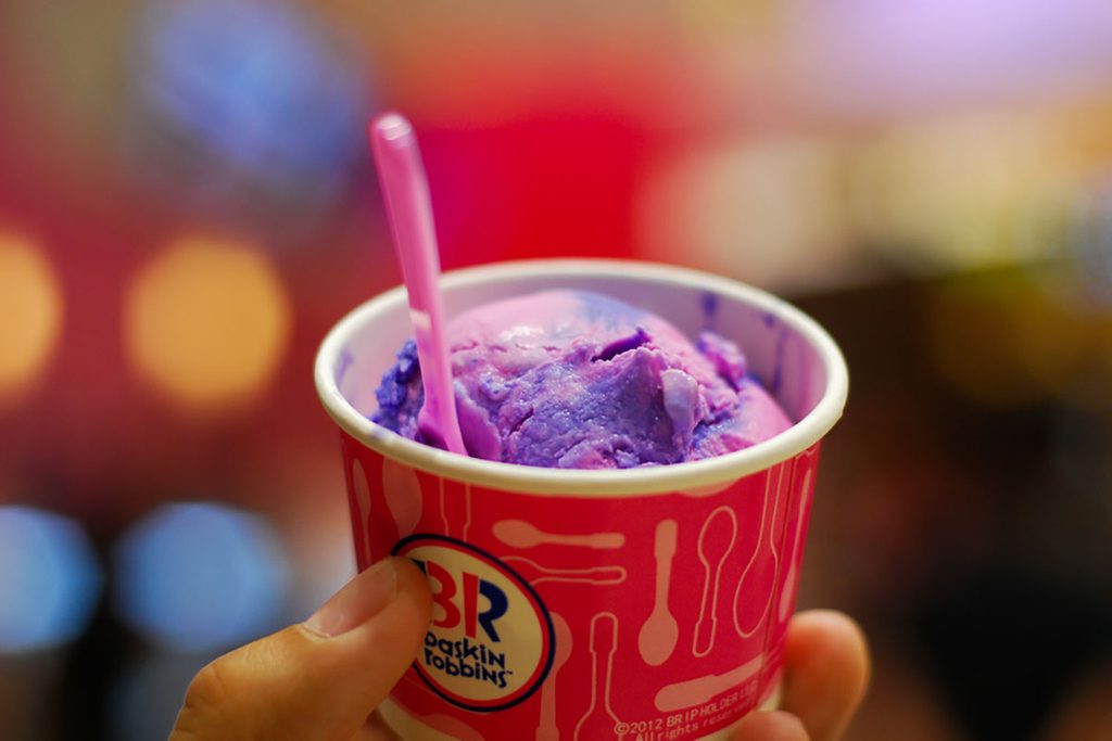 A cup of baskin robbins ice cream with blur background of colorful light