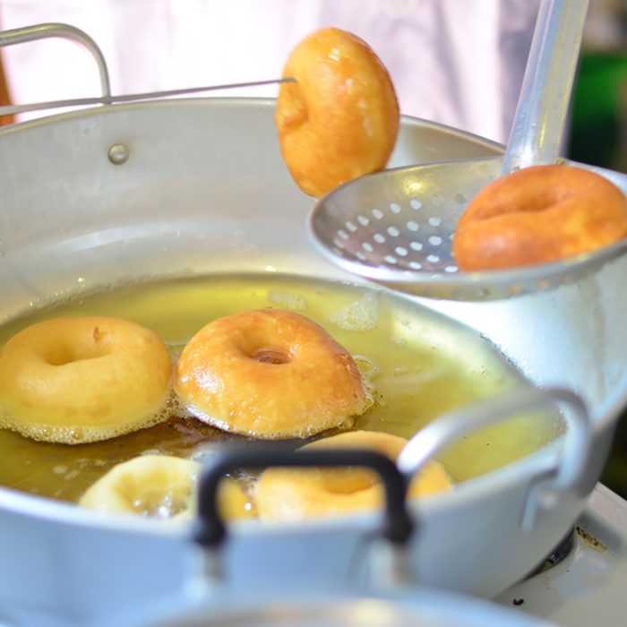 Frying donuts in oiled pans