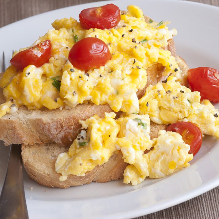 Toast with scrambled eggs and cherry tomatoes